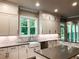 Modern kitchen with white cabinets, subway tile backsplash, and farm sink at 11355 Bennett Ln, Johns Creek, GA 30097