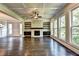 Spacious living room with fireplace and wall of windows offering natural light at 11355 Bennett Ln, Johns Creek, GA 30097