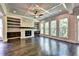 Spacious living room with fireplace, built-in shelving, and hardwood floors at 11355 Bennett Ln, Johns Creek, GA 30097