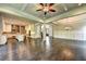 Open living room with coffered ceiling, hardwood floors, and fireplace at 11355 Bennett Ln, Johns Creek, GA 30097