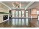 Bright living room with hardwood floors, coffered ceiling, and wall of windows at 11355 Bennett Ln, Johns Creek, GA 30097