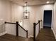 Open staircase with dark hardwood floors and white railings at 11355 Bennett Ln, Johns Creek, GA 30097