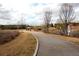 Paved walking trail near a pond with gazebo and fountain at 11355 Bennett Ln, Johns Creek, GA 30097