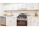 Updated kitchen with stainless steel appliances and white cabinetry at 1302 Woodcliff Dr, Atlanta, GA 30350