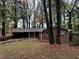 Brick ranch house with carport, surrounded by mature trees at 2820 Arlington Rd, Atlanta, GA 30344