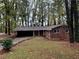Brick ranch home nestled on a wooded lot with a large front yard at 2820 Arlington Rd, Atlanta, GA 30344