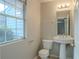 Small bathroom with pedestal sink and window at 6390 Alford Cir, Lithonia, GA 30058