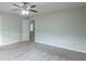 Spacious bedroom with ceiling fan and door to hallway at 6390 Alford Cir, Lithonia, GA 30058