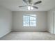 Bright bedroom with ceiling fan and window at 6390 Alford Cir, Lithonia, GA 30058