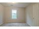 Bright bedroom featuring a large window and neutral decor at 6390 Alford Cir, Lithonia, GA 30058