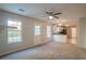 Open living space with kitchen views and neutral carpet at 6390 Alford Cir, Lithonia, GA 30058