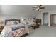 Bedroom with a queen-size bed, a sofa and plenty of light at 5685 Ansley Ridge Ln, Suwanee, GA 30024