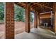 Covered brick patio with access to backyard at 1006 Manchester Way, Roswell, GA 30075