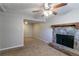 Spacious basement with a stone fireplace and ceiling fan at 2076 Scarbrough Dr, Stone Mountain, GA 30088