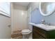 Clean bathroom with shower/tub combo and dark brown vanity at 2076 Scarbrough Dr, Stone Mountain, GA 30088