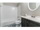Clean bathroom with bathtub, toilet, and dark brown vanity at 2076 Scarbrough Dr, Stone Mountain, GA 30088