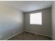 Simple bedroom with a window and neutral wall paint at 2076 Scarbrough Dr, Stone Mountain, GA 30088