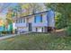 Two-story house with gray siding, dark brown door and attached garage at 2076 Scarbrough Dr, Stone Mountain, GA 30088