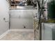 Basement laundry area with tile floor, shelving, and utilities at 2076 Scarbrough Dr, Stone Mountain, GA 30088