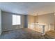 Spacious living room with neutral carpeting and a view to a staircase at 2076 Scarbrough Dr, Stone Mountain, GA 30088