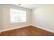 Well-lit bedroom with wood flooring and window at 4125 Bradford Walk Trl, Buford, GA 30519