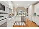 Modern white kitchen with stainless steel appliances and hardwood floors at 1247 Nottoway Trl, Marietta, GA 30066