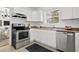 Modern kitchen featuring stainless steel appliances and white cabinetry at 2110 Dellwood Pl, Decatur, GA 30032