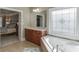 Bathroom with a corner bathtub, vanity, and stained glass window at 4821 Moon Chase Dr, Buford, GA 30519