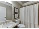 Clean bathroom with a shower/tub combo, white vanity, and neutral decor at 4821 Moon Chase Dr, Buford, GA 30519