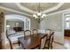 Elegant dining room featuring a spacious table, chandelier, and views into the living area at 4821 Moon Chase Dr, Buford, GA 30519