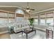 Relaxing sunroom with hardwood floors, comfortable seating, and abundant natural light at 4821 Moon Chase Dr, Buford, GA 30519