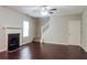 Living room with hardwood floors, fireplace, and stairs at 6899 Dalehollow Dr, Lithonia, GA 30058