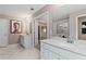 Bathroom with double vanity, large mirror, and marble flooring at 236 Ruthe Cvs, Locust Grove, GA 30248