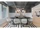 Modern dining room with black and white geometric rug and statement lighting at 236 Ruthe Cvs, Locust Grove, GA 30248