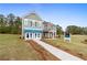 Two-story home with gray siding, brick accents, and a landscaped lawn at 236 Ruthe Cvs, Locust Grove, GA 30248
