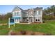 Two-story home with gray siding, brick accents, and a landscaped lawn at 236 Ruthe Cvs, Locust Grove, GA 30248