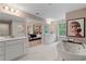 Spa-like bathroom with double vanities, large tub, and shower at 236 Ruthe Cvs, Locust Grove, GA 30248