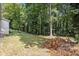 Partially shaded backyard with some cut branches laying on the grass at 4218 Tara Dr, Forest Park, GA 30297