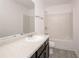 Bathroom with tub, shower, vanity, and dark cabinets at 884 Lobdale Falls Dr, Lawrenceville, GA 30045