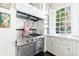 Modern kitchen with stainless steel range and marble backsplash at 401 Peachtree Battle Nw Ave, Atlanta, GA 30305