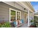 Inviting front porch with a wooden swing and lush greenery at 2956 Hogan Rd, East Point, GA 30344