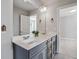 Double vanity bathroom with gray cabinets and a large mirror at 622 Denali Dr, Mableton, GA 30126