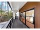 Modern back patio with glass doors and wood siding, offering a tranquil wooded view at 4366 Skyland Ne Dr, Atlanta, GA 30342