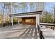 Covered back patio with a wood wall and a view of the trees at 4366 Skyland Ne Dr, Atlanta, GA 30342