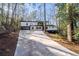 Modern home on a hillside with a long driveway and wooded lot at 4366 Skyland Ne Dr, Atlanta, GA 30342