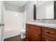 Updated bathroom with granite vanity, wood cabinets, and a bathtub at 1526 Venetian Sw Dr, Atlanta, GA 30311