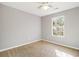 Bright bedroom with neutral walls and carpet, featuring a window and ceiling fan at 1526 Venetian Sw Dr, Atlanta, GA 30311