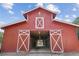 Red barn with large doors and X accents at 2054 Cook Rd, Oxford, GA 30054