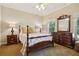 Bedroom with wooden bed frame, dresser and carpet flooring at 2054 Cook Rd, Oxford, GA 30054