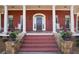 Elegant front door entrance with columns and rocking chairs at 2054 Cook Rd, Oxford, GA 30054